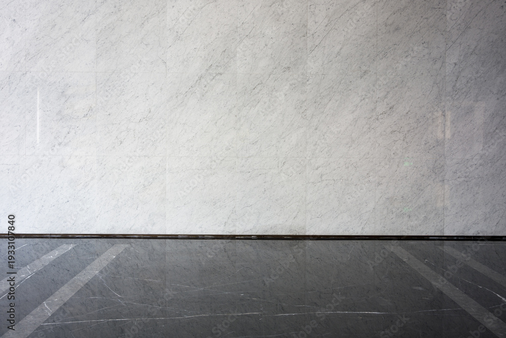 Fototapeta premium Gray white marble wall meeting dark gray tile floor with precise joint detail
