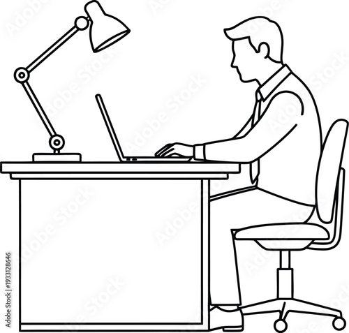 Businessman works diligently on his laptop computer at a desk with a.