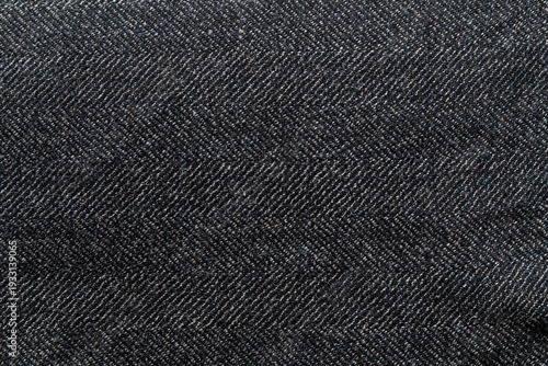 Herringbone wool textile close-up — moody gray tweed texture, soft woolen fibers, ideal seamless background for fashion and product layouts.