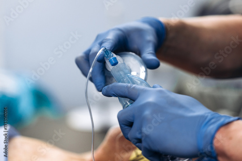 Hospital operating theater with anesthesiologist administering intubation anesthesia to patient. Operating room concept.
