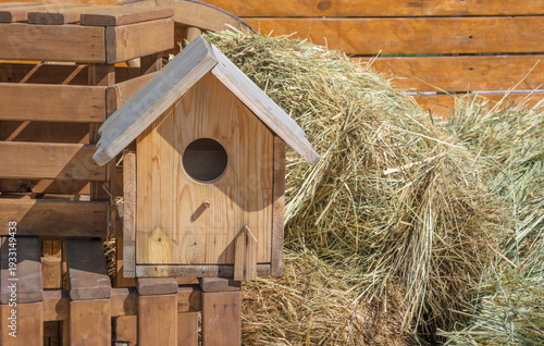 Wooden birdhouse on the background of a haystack