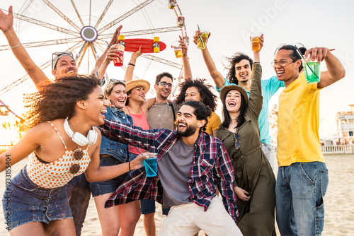 Multiracial group of friends having fun dancing at sunset beach party - Happy young people enjoying music festival on weekend vacation - Life style concept with guys and girls enjoying summer vacation