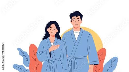 Portrait of a happy young man and woman wearing matching blue robes standing together against a warm sunset background.