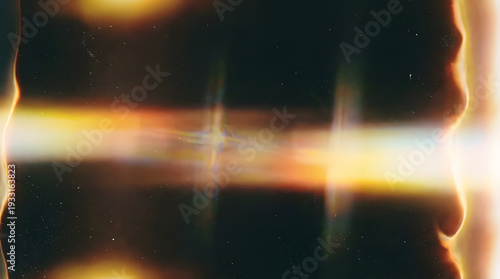 Abstract golden light flares and waves against a dark speckled background
