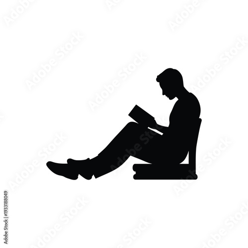 Silhouette of a Person Sitting and Reading a Book, Enjoying Leisure Time or Education.