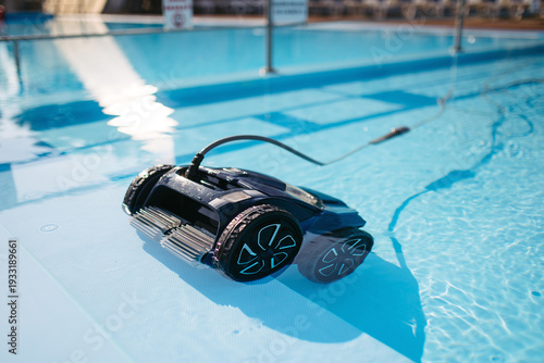 Photography Robotic pool cleaner working underwater to keep swimming pool clean