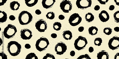 Abstract background with irregular black shapes on a cream color