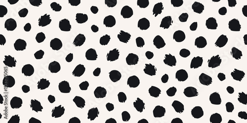 Abstract background with irregular black spots on a cream surface