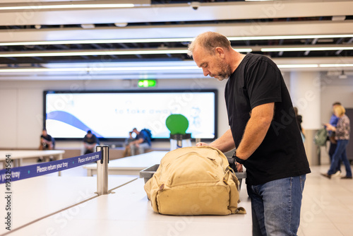 a man at a baggage checkpoint