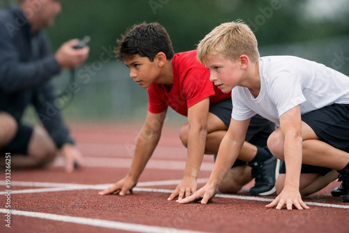 Two boys at sprint start on track