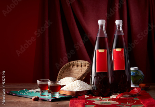 Two bottles of traditional Chinese rice wine and ingredients on table