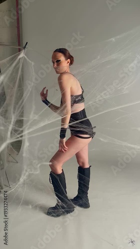 Female Hero Trapped in Giant Spider Webs in Studio