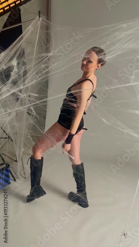 Gothic Model Posing in Spiderweb for Fashion Shoot