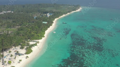 Wallpaper Mural Wide aerial landscape of Thoddoo island coastline showing a long white sand beach, lush green palm forest, anchored boats, and expansive shallow turquoise water with coral reefs. Torontodigital.ca
