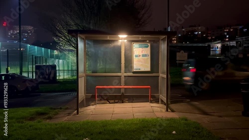 Brighton, United Kingdom - March 2nd 2026: empty bus stop at night with car driving past
