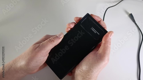 Power bank in woman’s hands, turning on and off