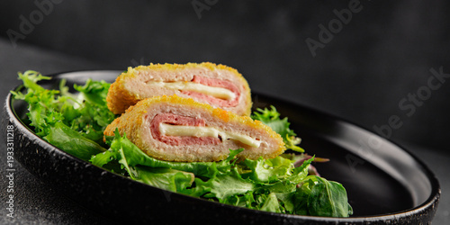 Cordn blue cutlet meat dish chicken fillet, ham, cheese tasty snack fresh gourmet food background on the table rustic food top view copy space keto and paleo diet 
