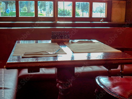 Reserved restaurant table with cutlery and tablecloth