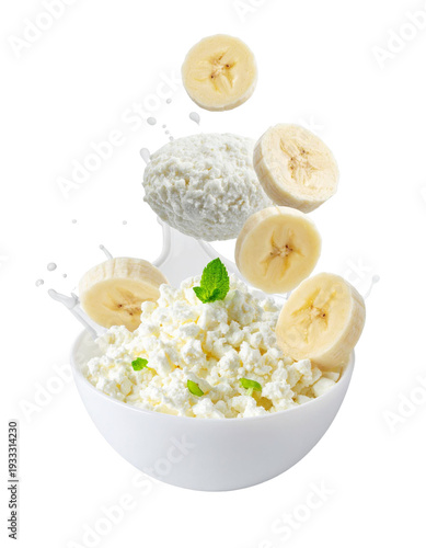 Cottage cheese and banana with milk splash in bowl