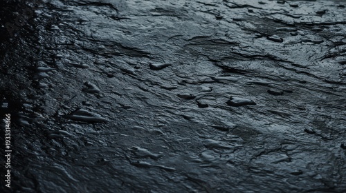 Wet slate texture, dark grey rock becoming almost black and shiny with moisture, rain effect