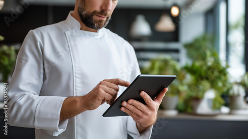 Wallpaper Mural Chef using tablet restaurant kitchen managing orders, culinary business technology embracing, food service digital operations, professional cooking automation, with copy space Torontodigital.ca