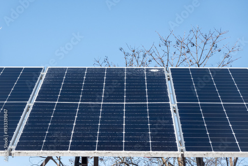 Cracked solar panel with visible impact damage on photovoltaic module installed outdoors. Broken glass surface on renewable energy system highlighting maintenance issues, energy loss