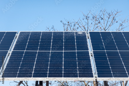 Cracked solar panel with visible impact damage on photovoltaic module installed outdoors. Broken glass surface on renewable energy system highlighting maintenance issues, energy loss