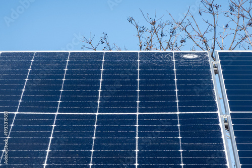 Cracked solar panel with visible impact damage on photovoltaic module installed outdoors. Broken glass surface on renewable energy system highlighting maintenance issues, energy loss