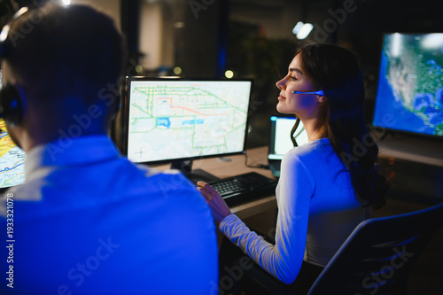 Картината върху платно Dispatcher team analyzing map data during night shift