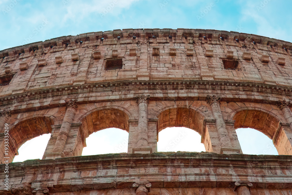 Obraz premium The Colosseum in Rome, an iconic symbol of the ancient Roman Empire, stands as a timeless monument to history, architecture, and human ingenuity.