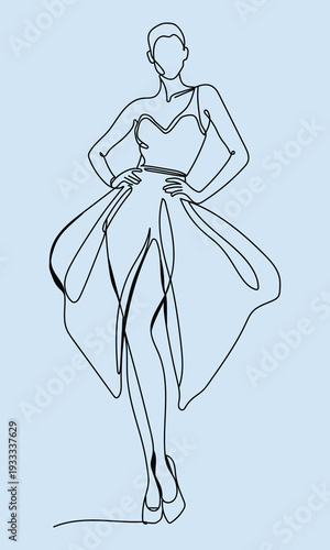 Elegant woman in a flowing dress with a confident pose and stylish hairdo