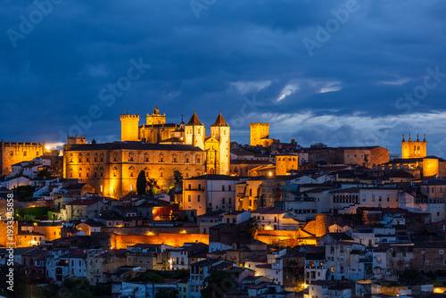 Aerial night view of illuminated historic Caceres
