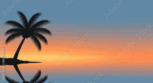 Silhouette of a lone palm tree on a tropical island at sunset.