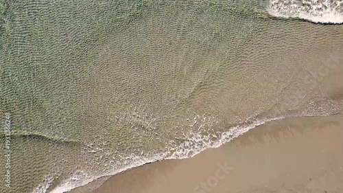 Waves on the sea, aerial drone view. Waves splashing on sandy beach. 