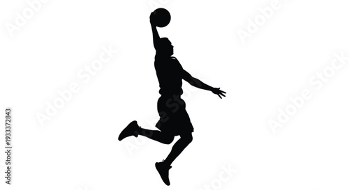 Silhouette of a basketball player in mid air preparing to dunk the ball