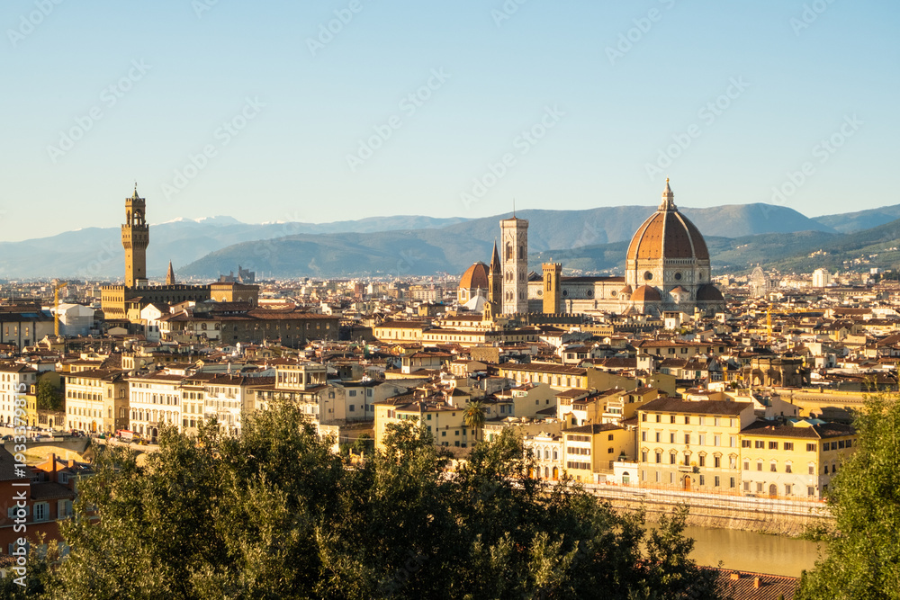Fototapeta premium View of Florence skyline with buildings and mountains during clear day in Italy