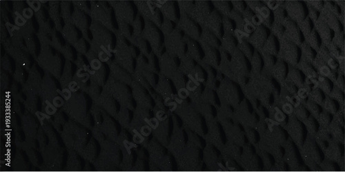 A seamless dark gray grunge texture featuring a rough black leather pattern surface with a macro textile material design suitable for a wallpaper backdrop