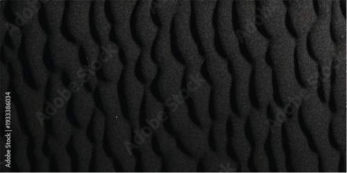 An abstract black leather texture background features natural ripples and wave patterns reminiscent of windblown desert sand dunes and dark water