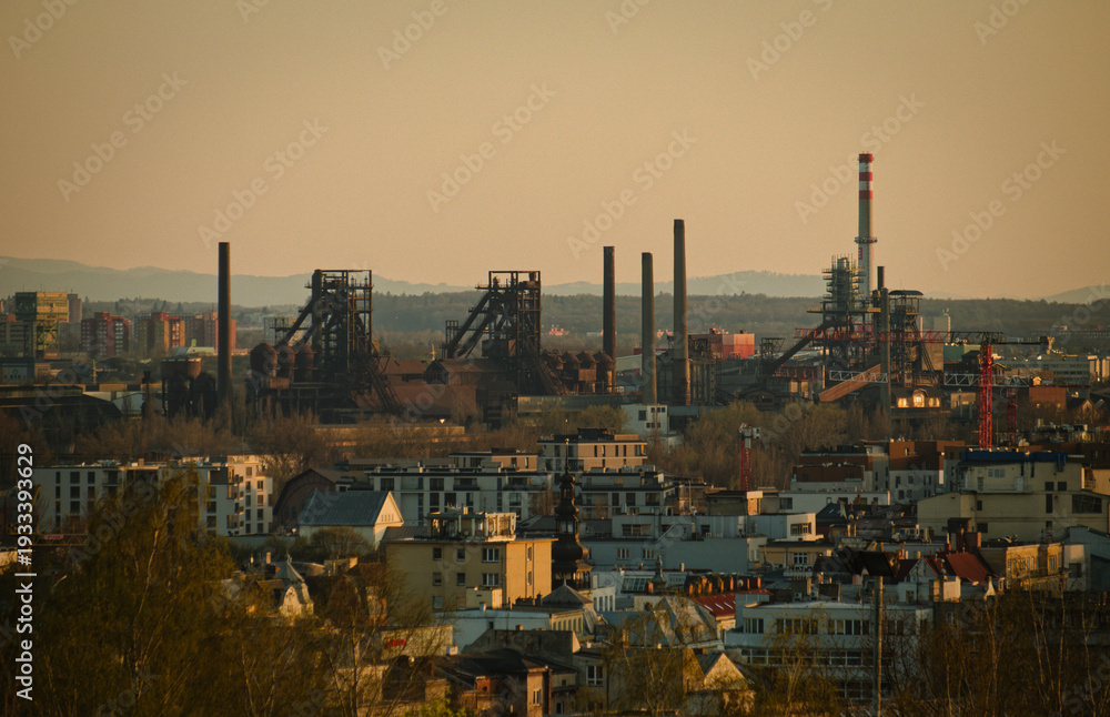 Obraz premium Czech Factories Glow At Dusk. Eerie Hazy Atmosphere Surrounds Rusting Factories And Chimneys