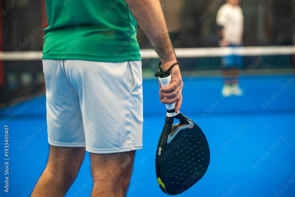 Fototapeta premium Two padel players with racket on court in action at tournament