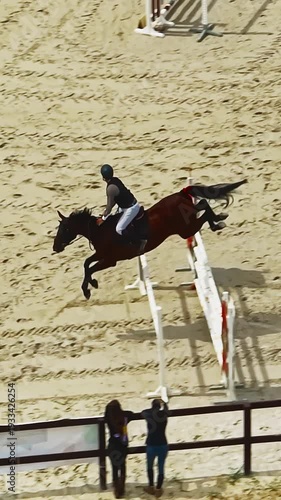 Aerial view of equestrian competition outdoors jumping hurdle