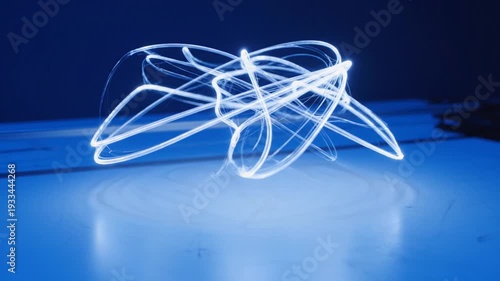 Dynamic Light Trails on Blue Surface Abstract Art.