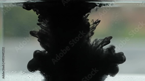 Black Ink Spreading in Water Creating Abstract Patterns and Textures.