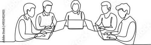 A group of people sitting around a table with laptops in a modern meeting room