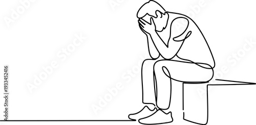 A man sits alone on a bench, overcome with sadness and despair, covering his face with his hands.