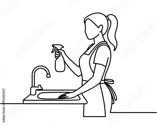 A woman wearing an apron is cleaning a sink with a spray bottle in her hand.