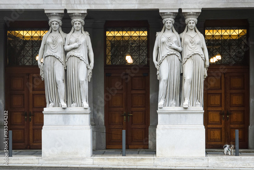 Photos Classical female caryatid statues supporting a portal of a historic building