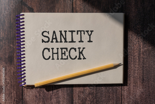 the word sanity CHECK is written on a wooden cubes structure . Can be used for Medical concept