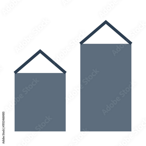 Two gray buildings with triangular roofs stand side by side indoors