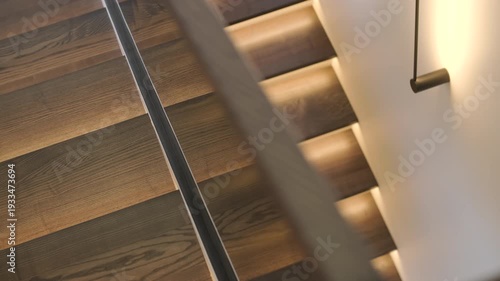 Modern interior design of a wooden staircase with integrated warm LED strip